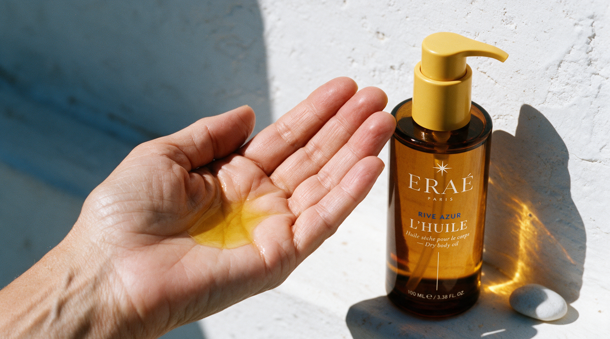 HERO · palm holding a real pool of oil, tilted, bottle in frame